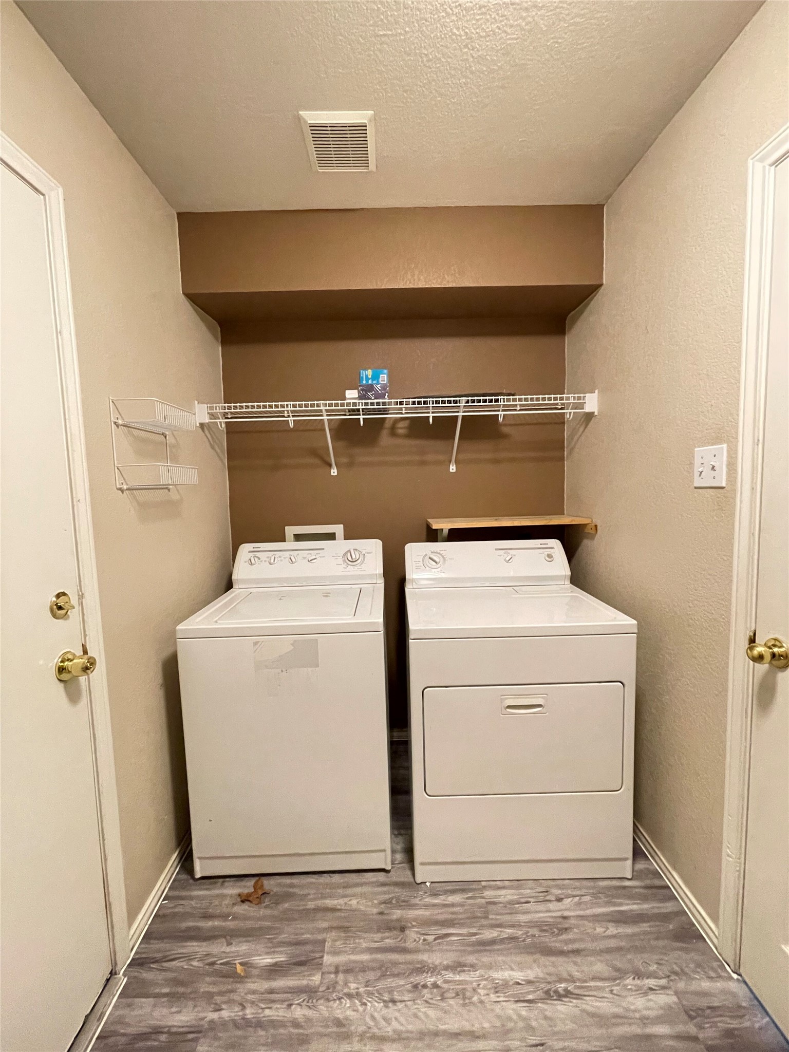 3638 Windhill Loop Round Rock, TX 78681 - Photo 28 of 32 Dedicated laundry area featuring wood-finish flooring, a suspended wire shelf, and an additional wall-mounted wire caddy
