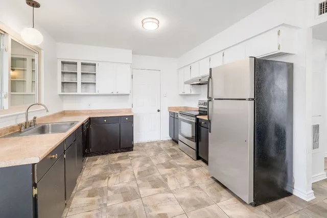 a bathroom with a sink mirror and a shower