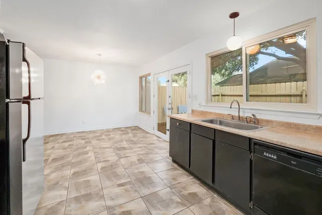 a view of wooden floor and a chandelier fan in a room