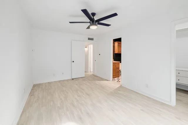 a bathroom with a granite countertop toilet sink and mirror