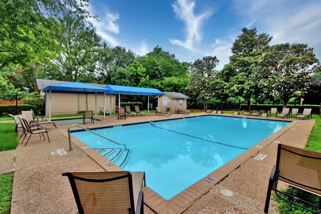 a front view of a house with yard and green space