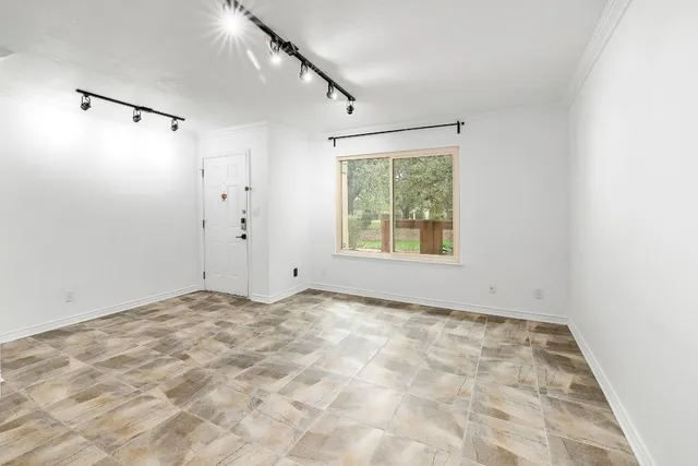 a view of an empty room with windows