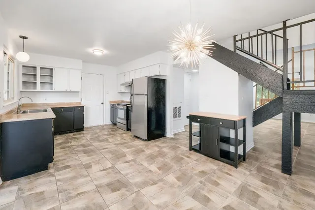 a view of a kitchen with microwave and cabinets