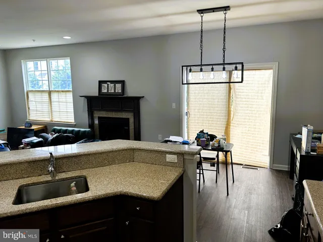 a kitchen with a table chairs and wooden floor