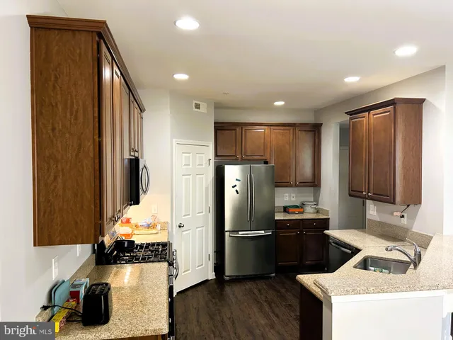 a kitchen with refrigerator and cabinets