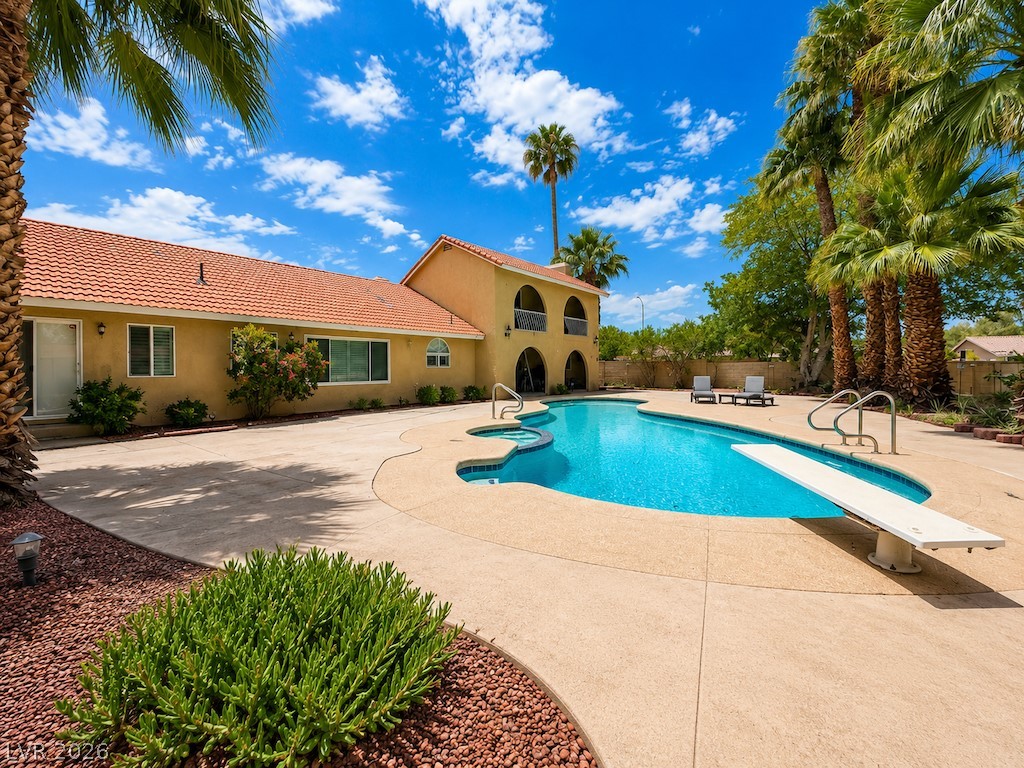 3010 East Viking Road Las Vegas, NV 89121 - Photo 4 of 48 A refreshing outdoor pool, complete with a diving board, beckons under a bright sky.