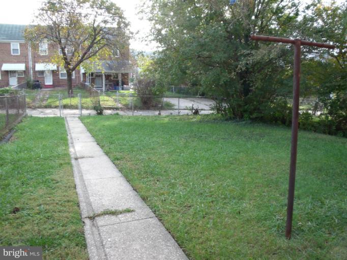 6147 Dunroming Road Baltimore, MD 21239 - Photo 1 of 10 a front view of a house with a yard