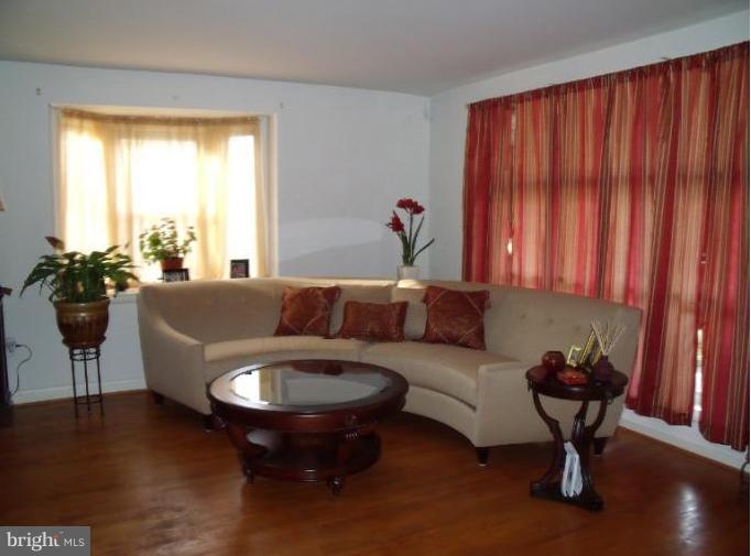 6147 Dunroming Road Baltimore, MD 21239 - Photo 2 of 10 a living room with furniture and a large window
