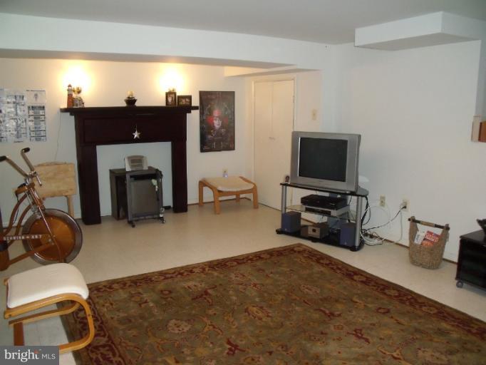 6147 Dunroming Road Baltimore, MD 21239 - Photo 3 of 10 a view of a livingroom with furniture and a flat screen tv