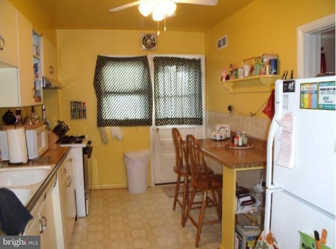 6147 Dunroming Road Baltimore, MD 21239 - Photo 6 of 10 a view of a dining room with furniture and a window
