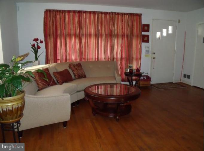 6147 Dunroming Road Baltimore, MD 21239 - Photo 7 of 10 a living room with furniture and a potted plant