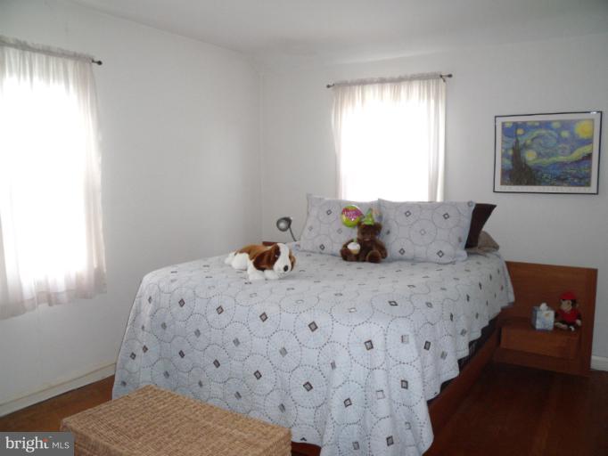6147 Dunroming Road Baltimore, MD 21239 - Photo 8 of 10 a bedroom with a bed and window