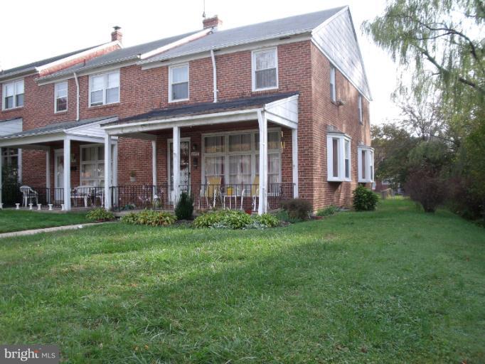 6147 Dunroming Road Baltimore, MD 21239 - Photo 10 of 10 front view of a brick house with a yard