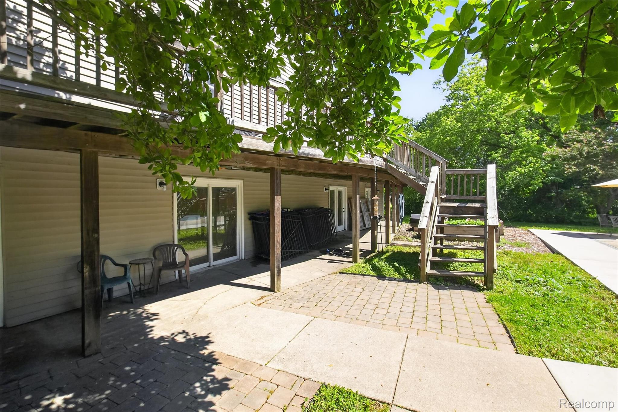8114 Chilson Road Pinckney, MI 48169 - Photo 29 of 32 Lower-level patio featuring paver stones and concrete