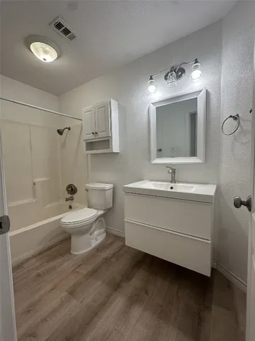 a bathroom with a double vanity sink mirror and toilet