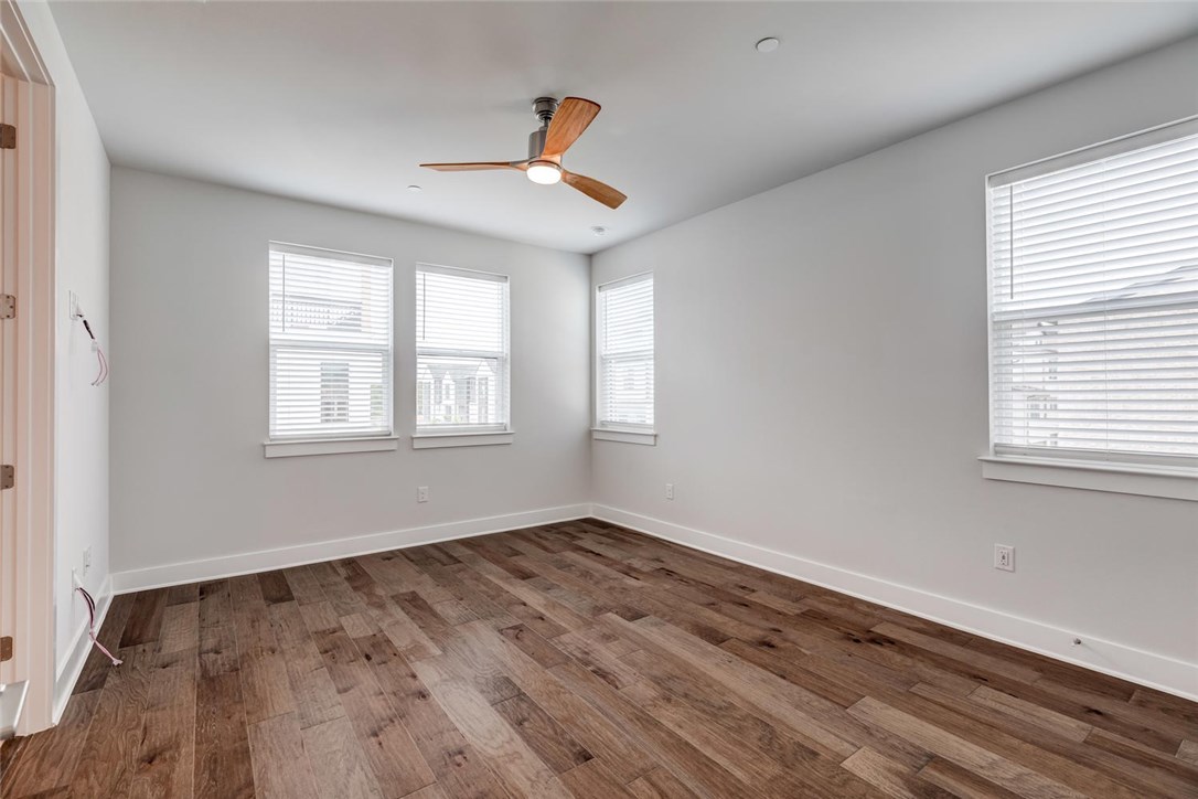 4600 Freedom Drive Austin, TX 78731 - Photo 19 of 40 a view of an empty room with wooden floor and a window