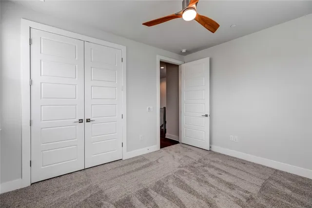 a bedroom with a large bed and a large window