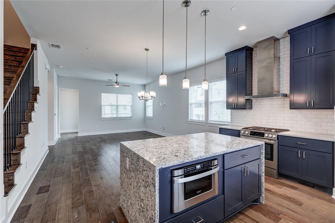 4600 Freedom Drive Austin, TX 78731 - Photo 3 of 40 a kitchen with stainless steel appliances granite countertop wooden cabinets stove a sink and dishwasher