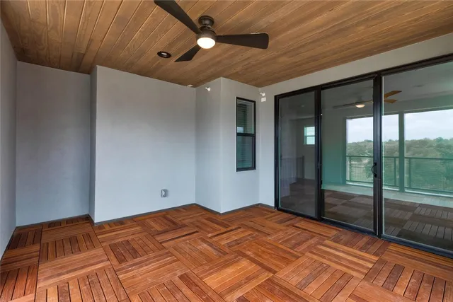 a view of a livingroom with wooden floor and a ceiling fan