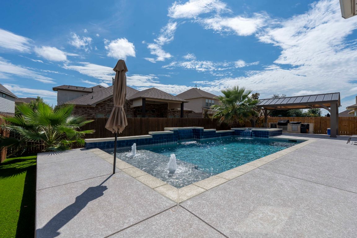 3301 Falconers Way Pflugerville, TX 78660 - Photo 11 of 39 View of pool featuring a patio, a fenced backyard, a pool with connected hot tub, and area for grilling