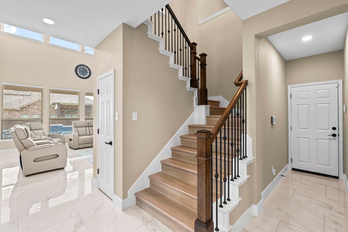 3301 Falconers Way Pflugerville, TX 78660 - Photo 17 of 39 Stairway with marble finish flooring, recessed lighting, and a high ceiling
