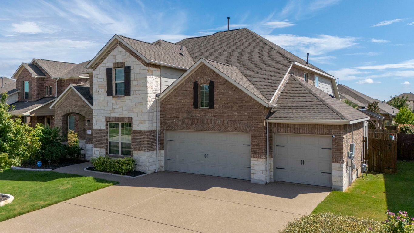 3301 Falconers Way Pflugerville, TX 78660 - Photo 2 of 39 French provincial home with roof with shingles, brick siding, concrete driveway, and stone siding