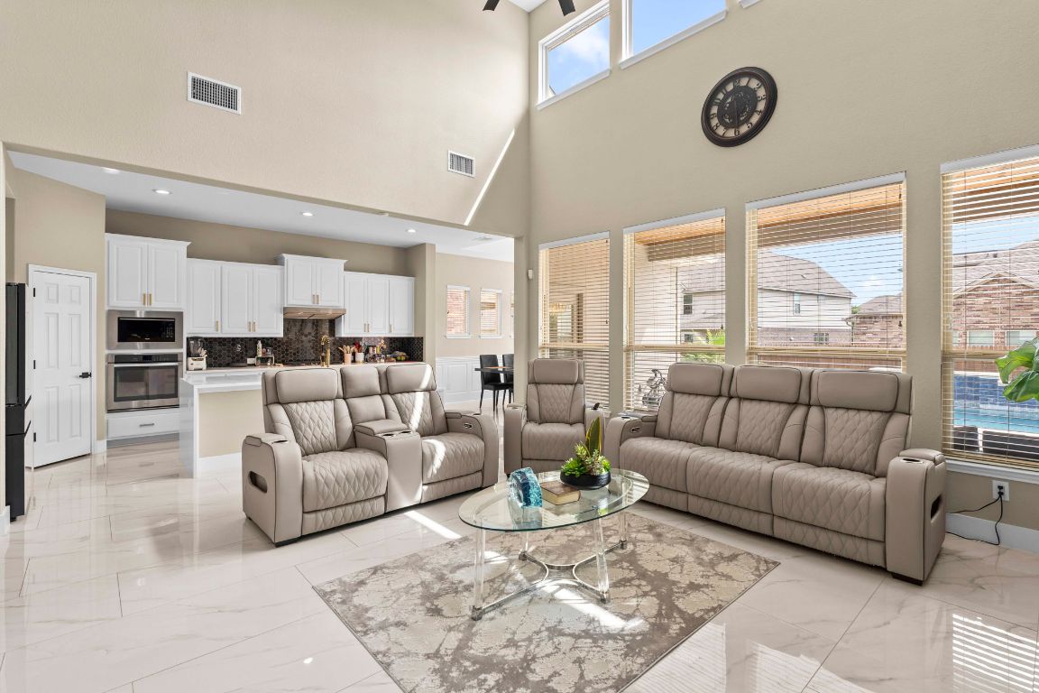 3301 Falconers Way Pflugerville, TX 78660 - Photo 22 of 39 Living room with light marble finish flooring and a towering ceiling