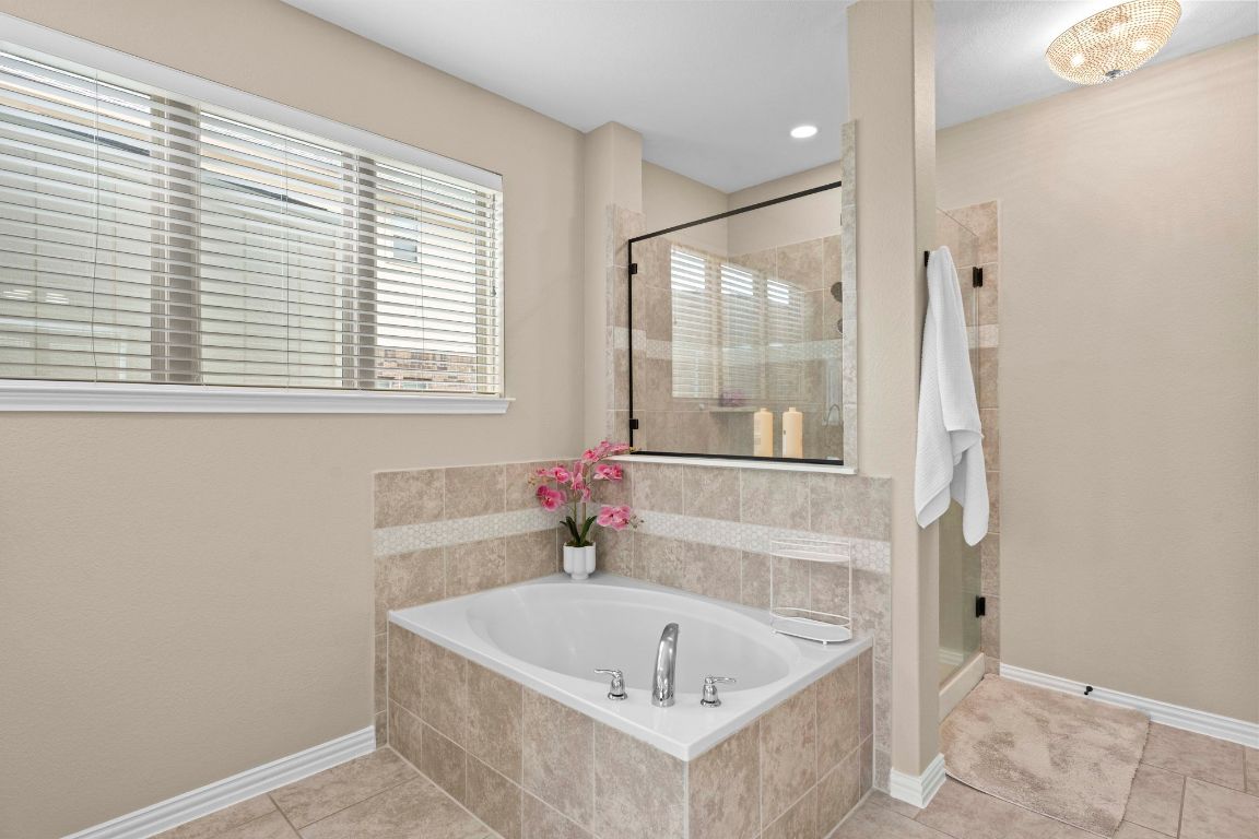 3301 Falconers Way Pflugerville, TX 78660 - Photo 26 of 39 Bathroom with light tile patterned floors, a bath, a shower stall, and recessed lighting