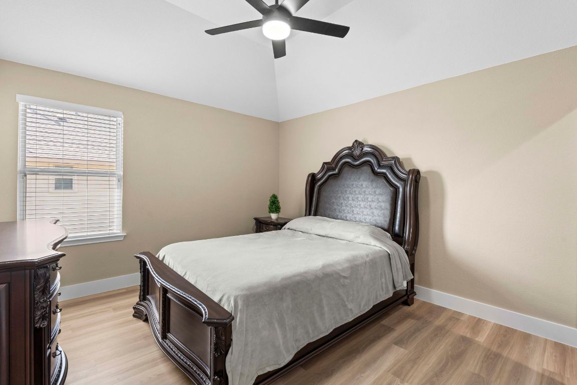 3301 Falconers Way Pflugerville, TX 78660 - Photo 33 of 39 Bedroom with light wood finished floors, a ceiling fan, and lofted ceiling