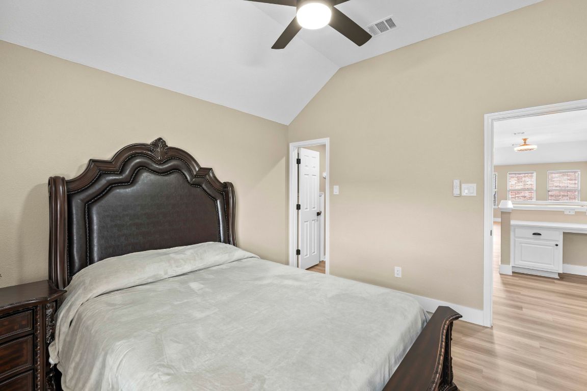 3301 Falconers Way Pflugerville, TX 78660 - Photo 34 of 39 Bedroom with vaulted ceiling, light wood finished floors, and ceiling fan