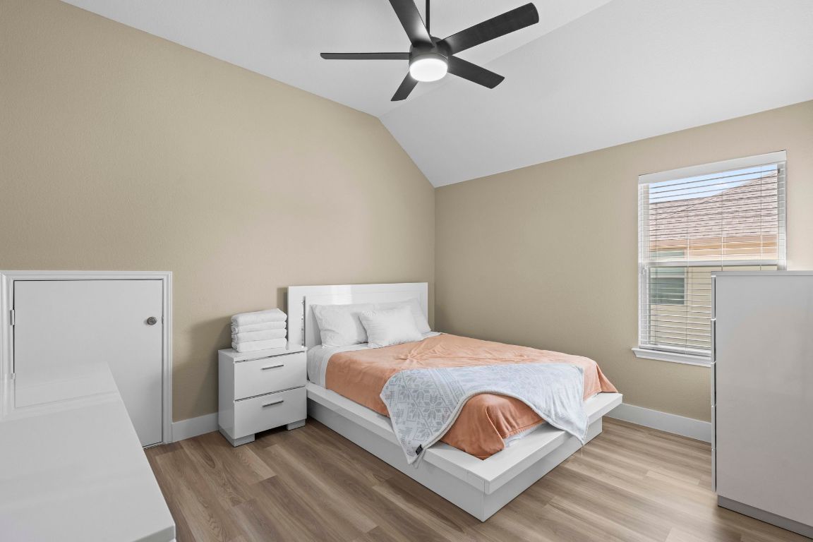 3301 Falconers Way Pflugerville, TX 78660 - Photo 36 of 39 Bedroom with light wood-style floors, lofted ceiling, and ceiling fan