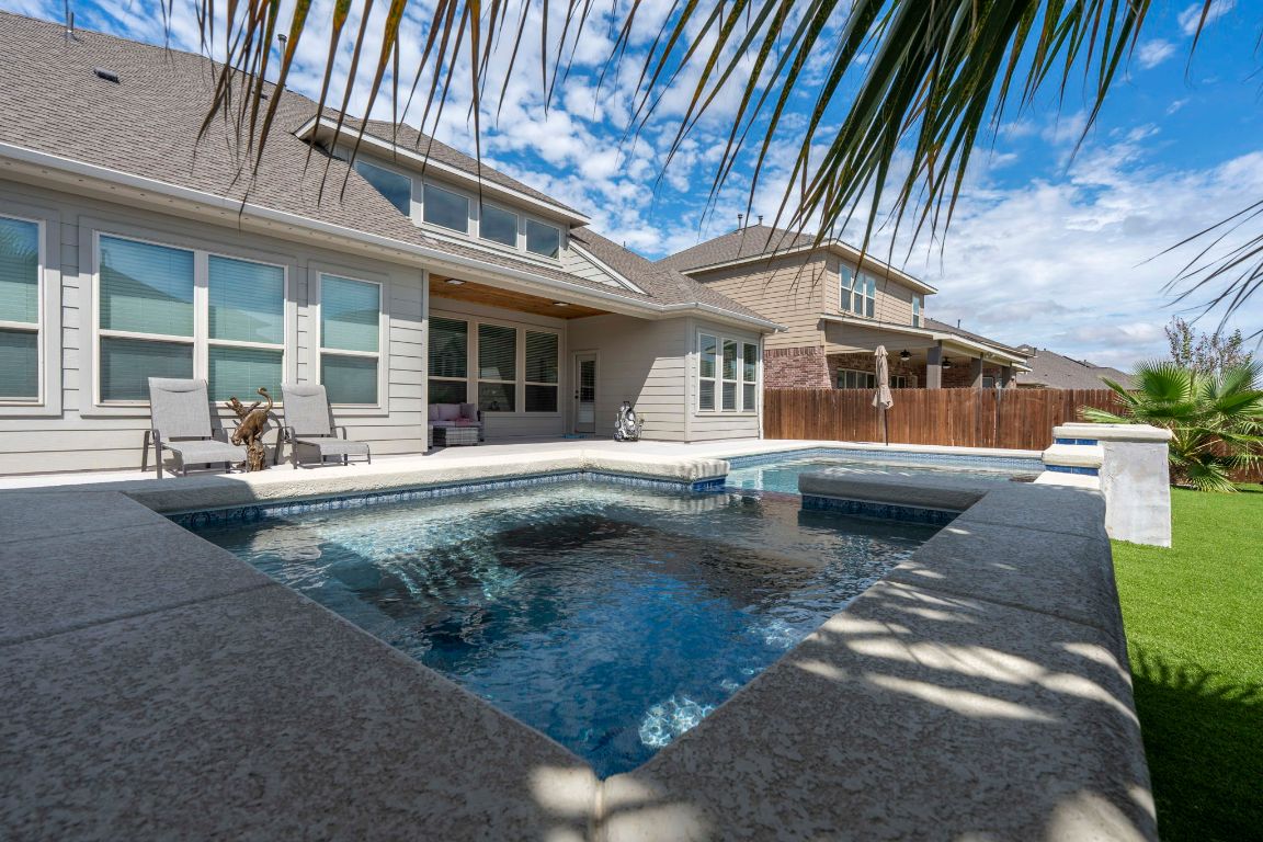 3301 Falconers Way Pflugerville, TX 78660 - Photo 9 of 39 View of swimming pool featuring a patio and a pool with connected hot tub