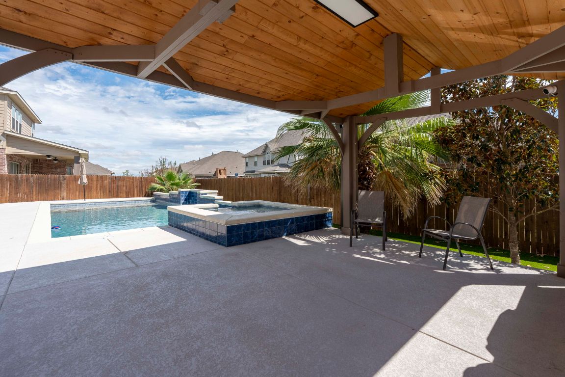 3301 Falconers Way Pflugerville, TX 78660 - Photo 10 of 39 Fenced backyard featuring a patio area and a pool with connected hot tub