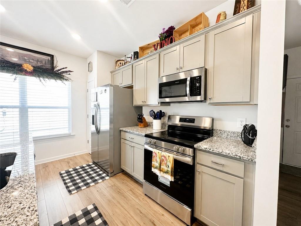 53 Bennett Way Rome, GA 30161 - Photo 3 of 42 a kitchen with stainless steel appliances a stove a sink and a microwave