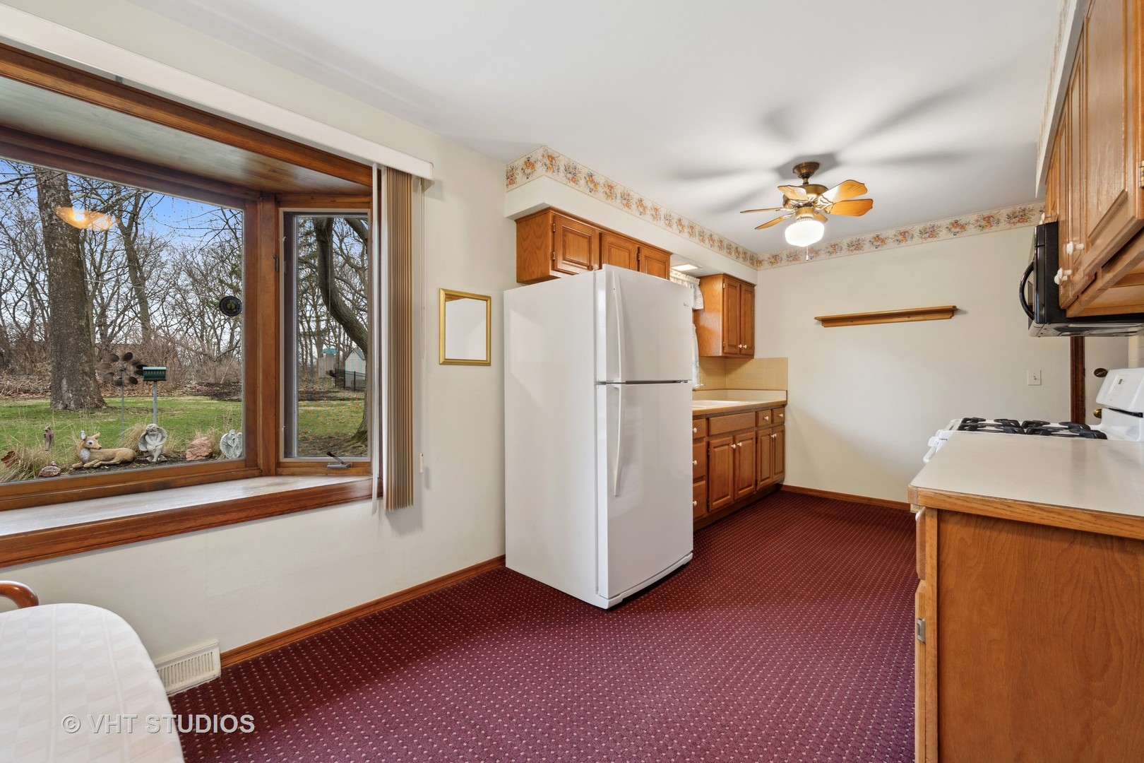 1426 Dunstan Road Geneva, IL 60134 - Photo 6 of 16 a kitchen with a refrigerator a stove and a window