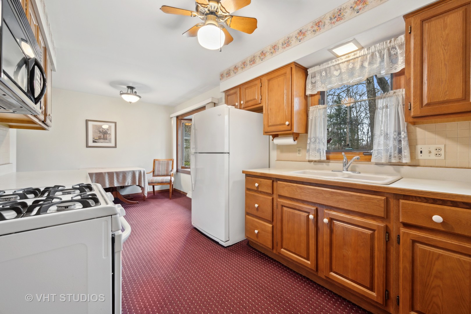 1426 Dunstan Road Geneva, IL 60134 - Photo 7 of 16 a kitchen with sink refrigerator and cabinets