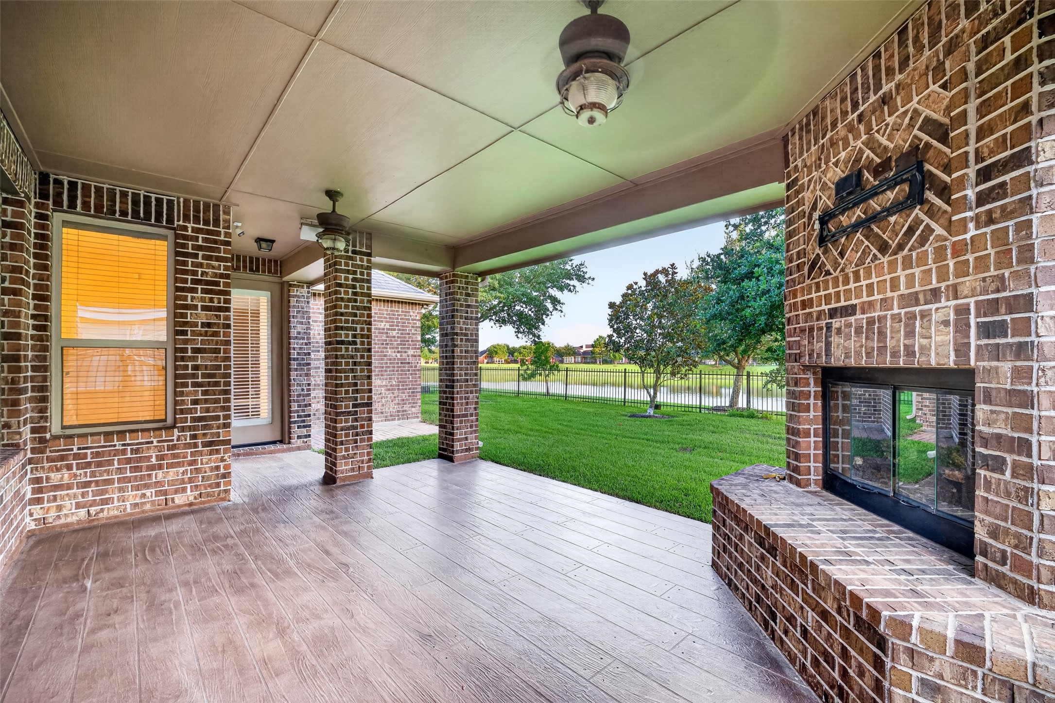 7930 Summer Night Lane Rosenberg, TX 77469 - Photo 40 of 48 Alternate view of the covered patio showcasing the outdoor fireplace and spacious seating area.
