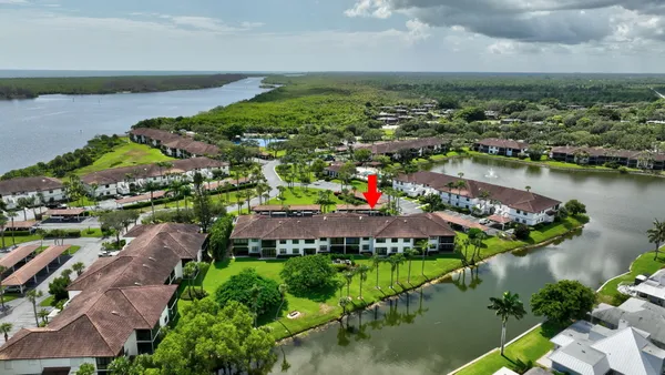 a aerial view of a house with a garden and lake view