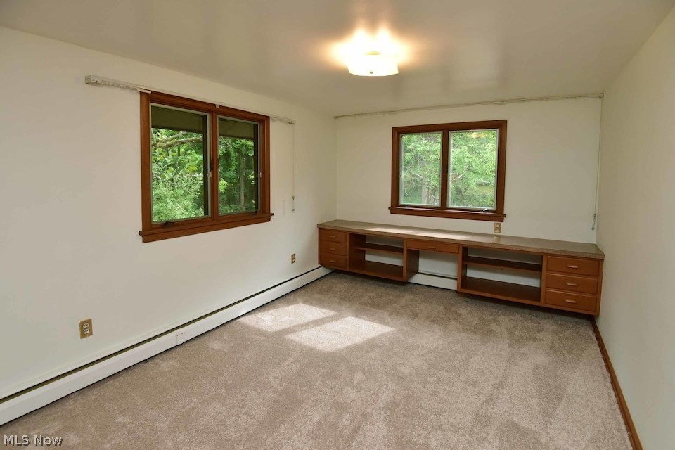 295 River Road Hinckley, OH 44233 - Photo 20 of 25 Another second level BR with built-in desk/shelving and generous closet storage with built in dresser, newly installed carpeting, and freshly painted! There are tranquil, idyllic woodland views from every window in this home!