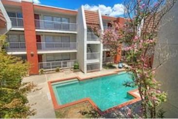3115 Helms Street, Unit 316 Austin, TX 78705 - Photo 1 of 19 a view of a backyard with table and chairs and potted plants