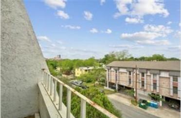 3115 Helms Street, Unit 316 Austin, TX 78705 - Photo 18 of 19 a view of a balcony with wooden floor & fence
