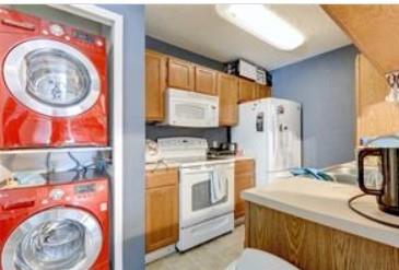 3115 Helms Street, Unit 316 Austin, TX 78705 - Photo 9 of 19 a kitchen with stainless steel appliances granite countertop a stove a washer and dryer