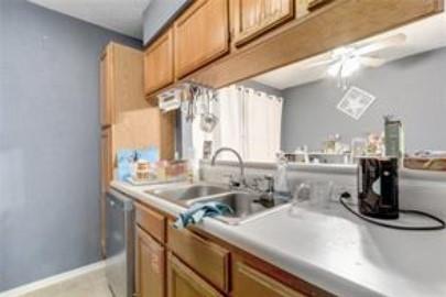 3115 Helms Street, Unit 316 Austin, TX 78705 - Photo 10 of 19 a kitchen with kitchen island a sink appliances cabinets and a large window