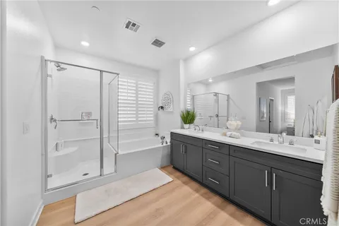 a bathroom with a granite countertop sink mirror and bathtub