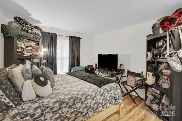 a bedroom with a bed and flat screen tv