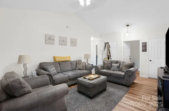 a living room with furniture and a lamp