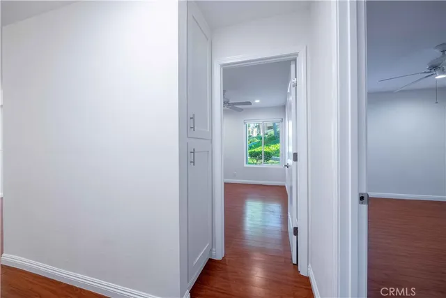 a view of a hallway with wooden floor