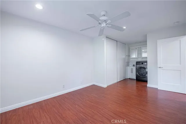 a view of empty room with wooden floor