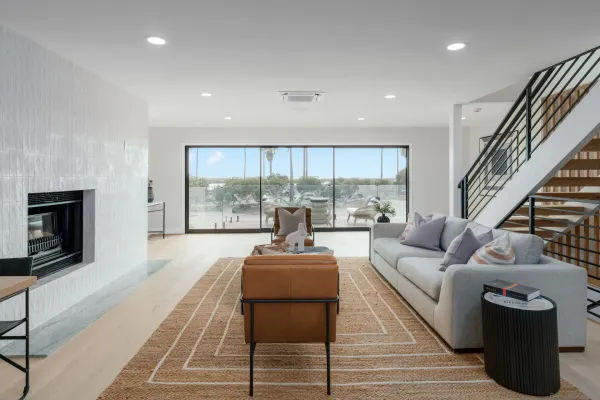 a living room with furniture fireplace and a large window