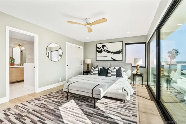 a bedroom with a bed and a painting on the wall